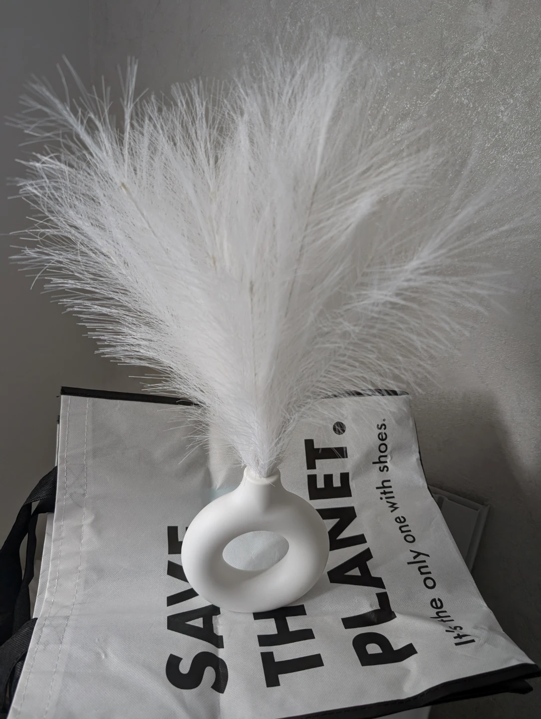 White donut vase with faux pampas grass