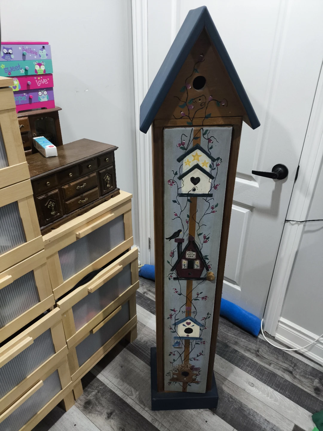 Tall Wooden Storage Cabinet with Decorative Birdhouse Design