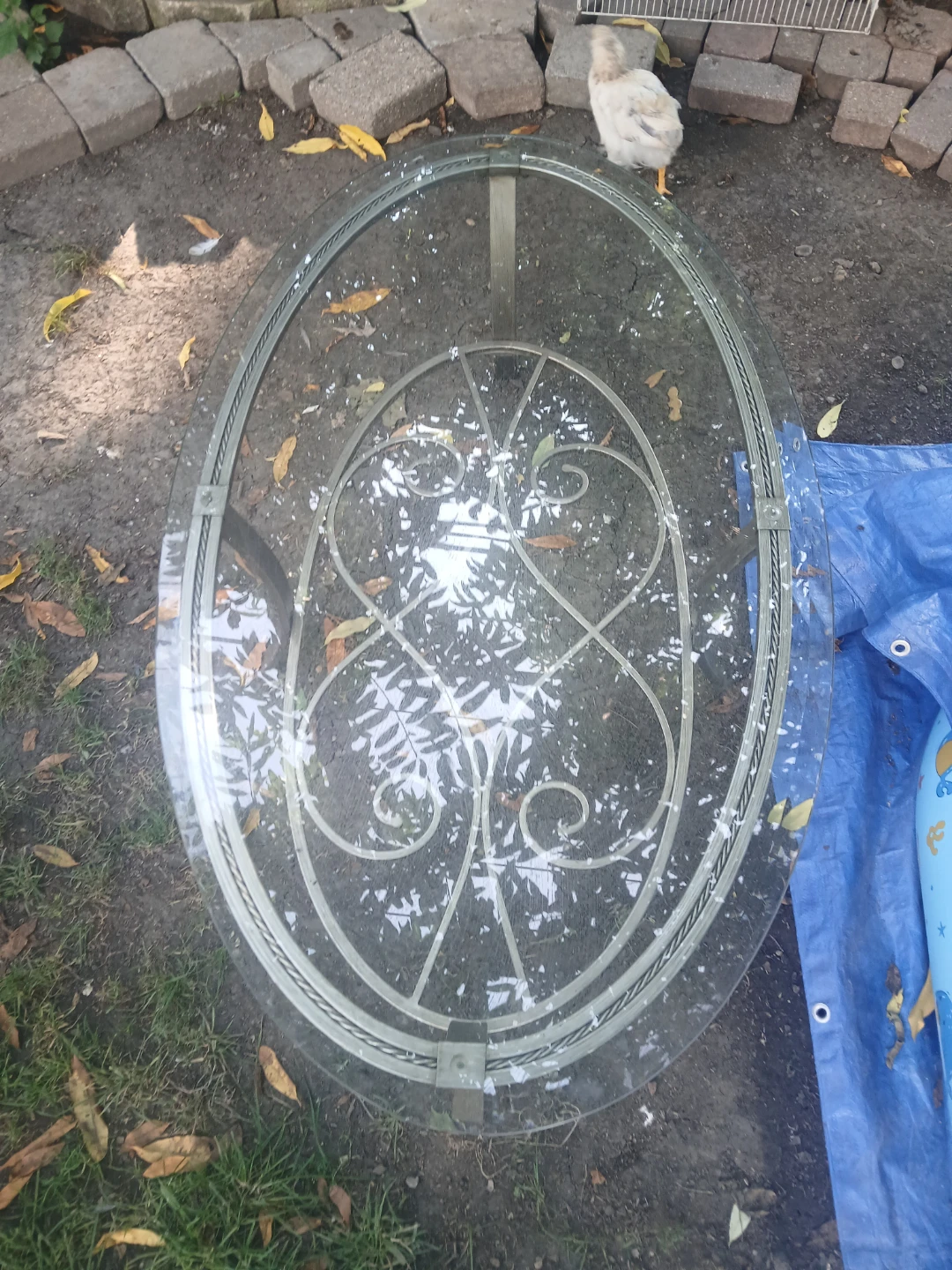 Oval Glass Coffee Table with Metal Scrollwork Base