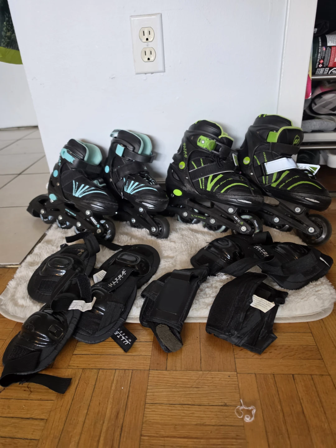 2 pairs of inline skates with protective gear, ages 6 and 8.