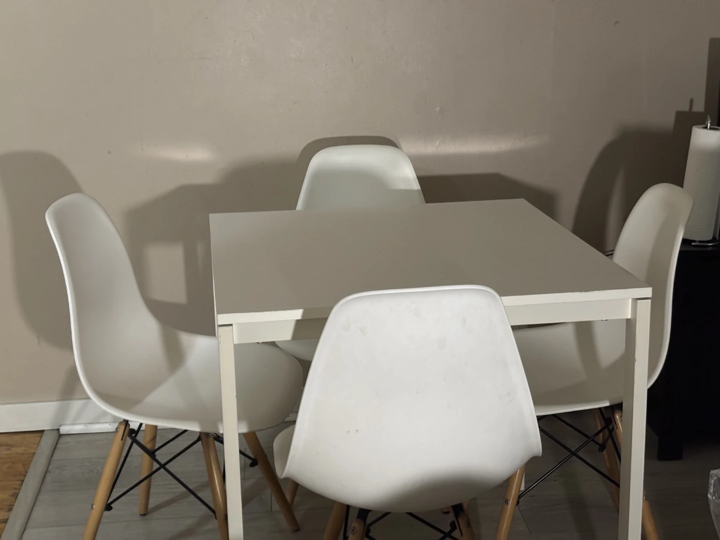 White dining table with four matching chairs