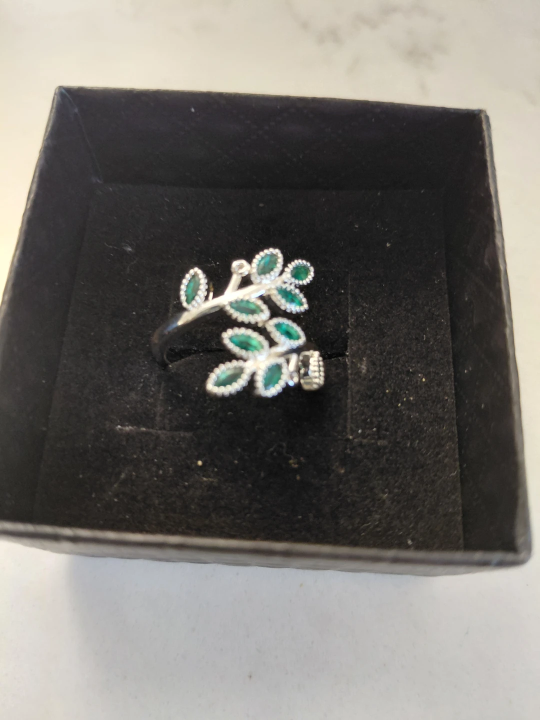 Silver-toned leaf ring with green stones
