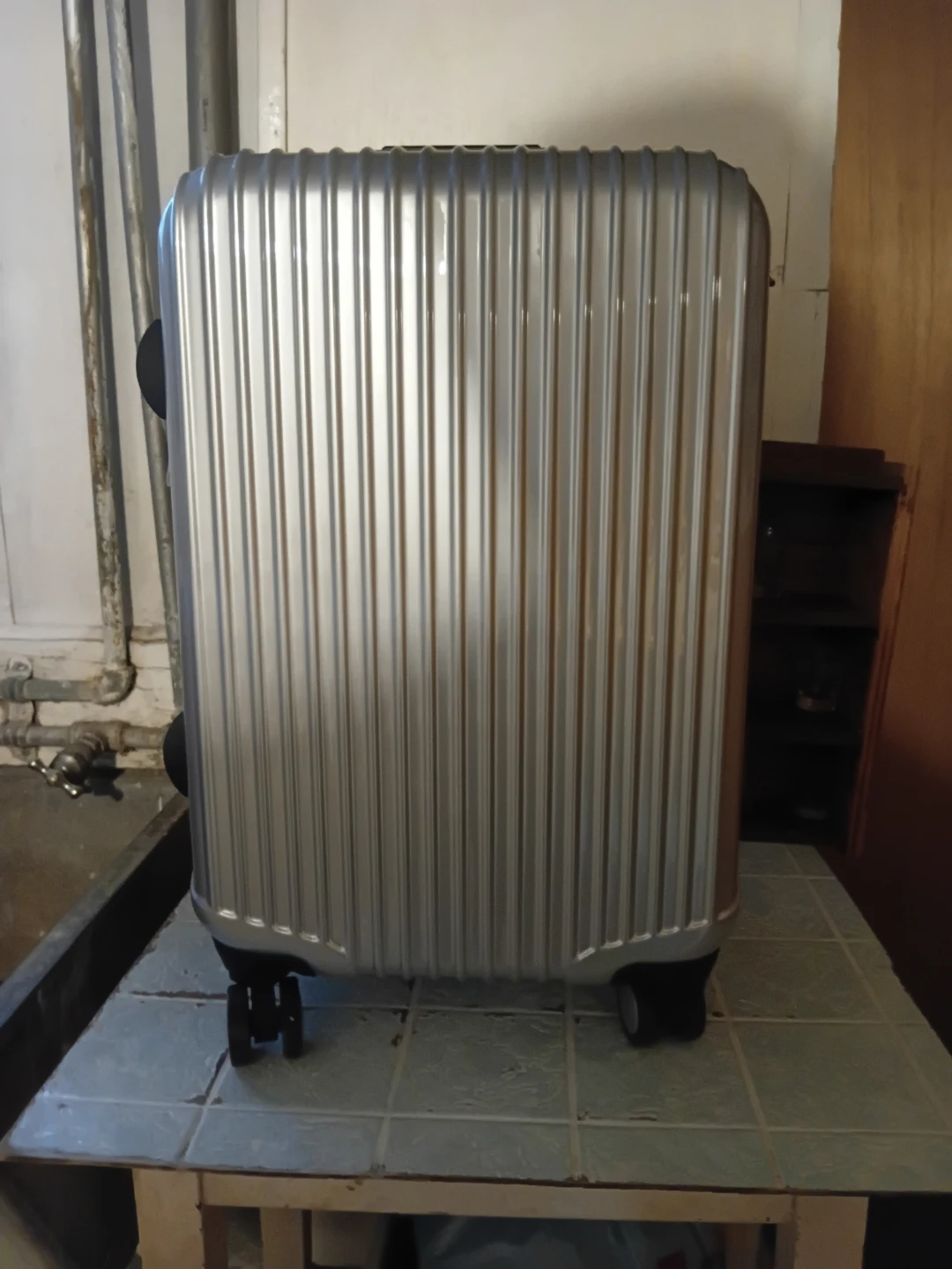 Silver hard-shell carry-on suitcase