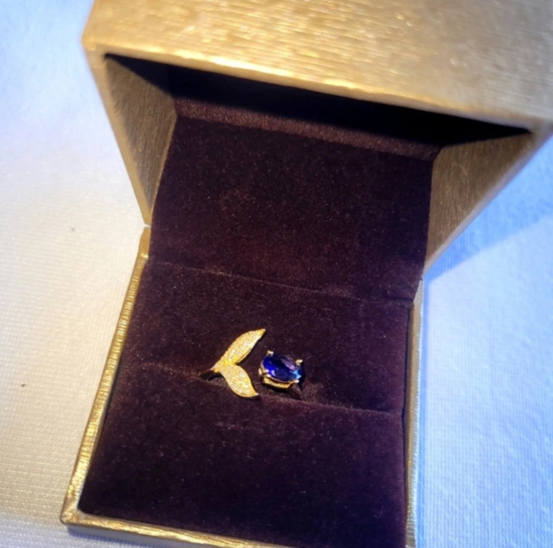 Gold-tone ring with blue stone and leaf detail