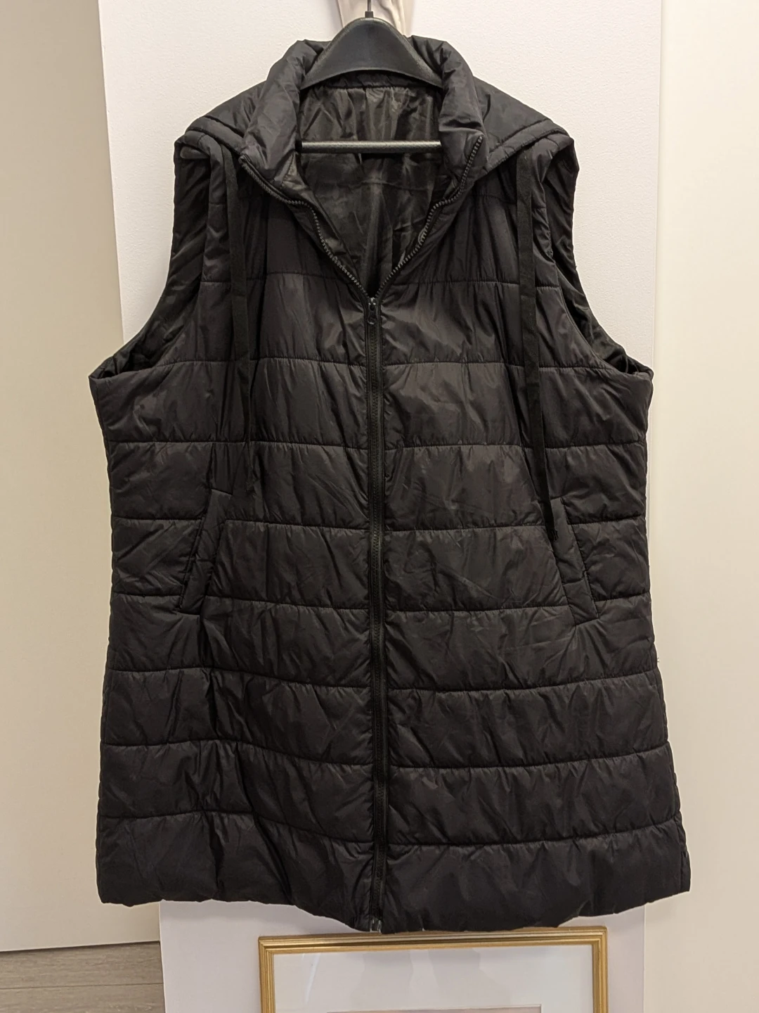 Size 2-3X black longer quilted vest. Fits below bum.