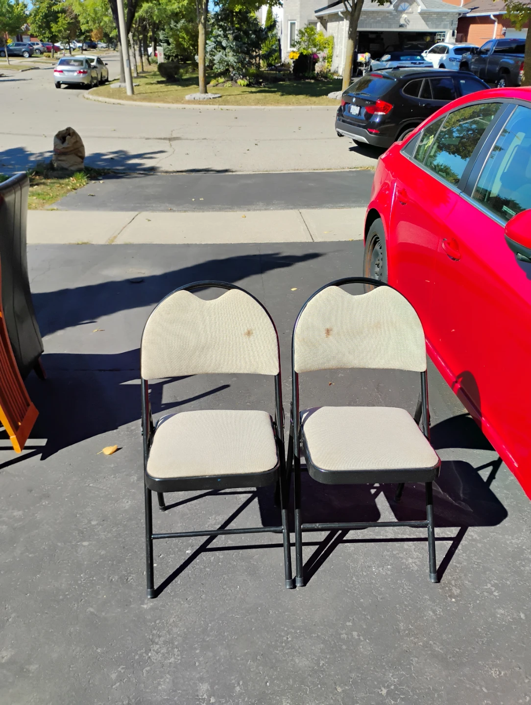 2 Black Folding Chairs with Beige Fabric Seats