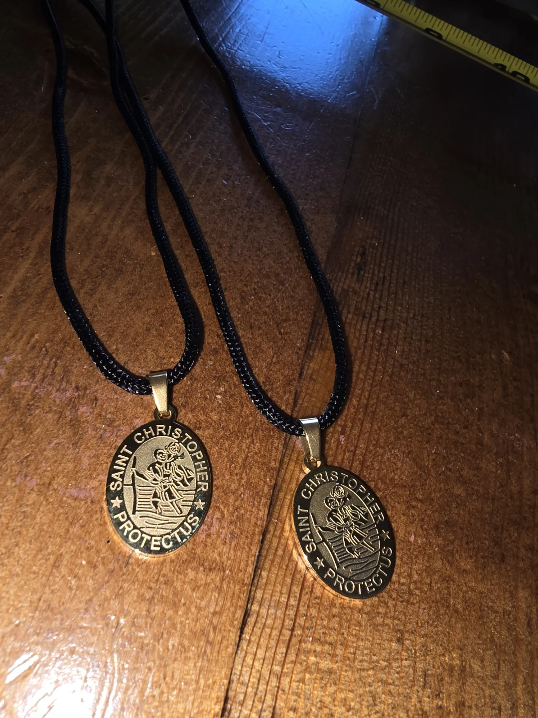 Two Saint Christopher Medals with Black Cords