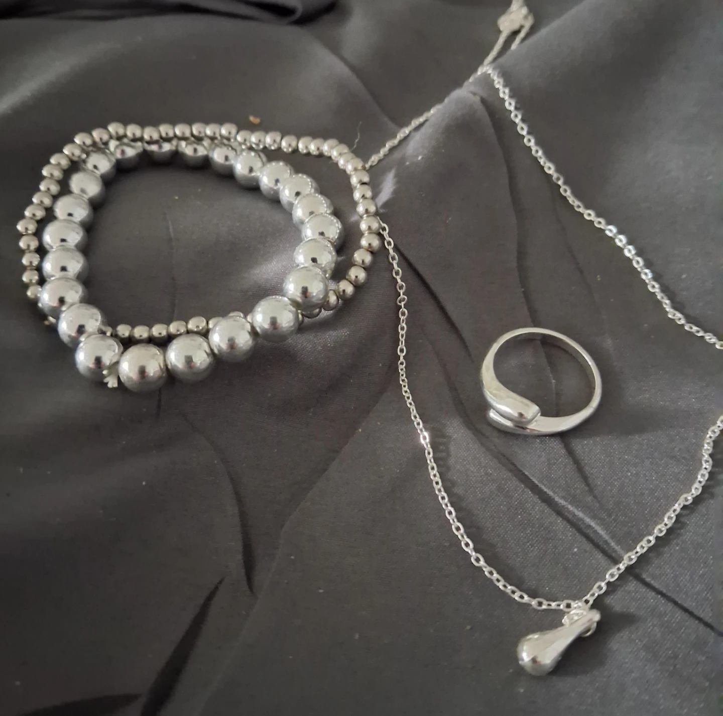 Silver-toned jewelry set with bracelets, ring and necklace