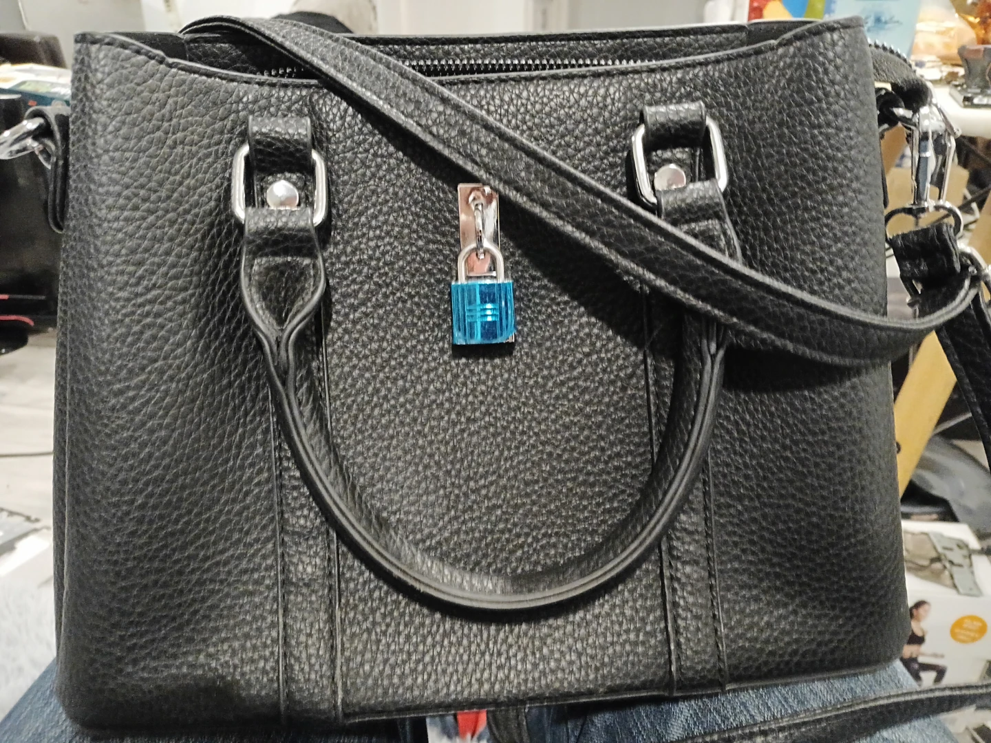 Black structured handbag with padlock detail