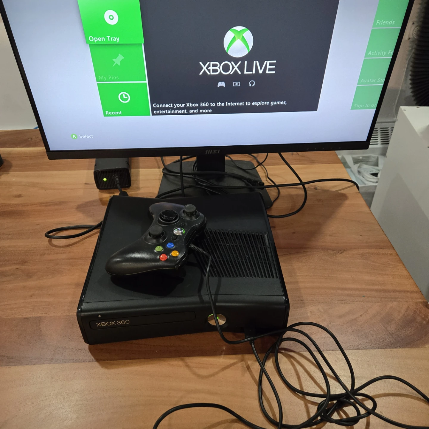 Xbox 360 S console. 4gb storage. wired controller, power cables.