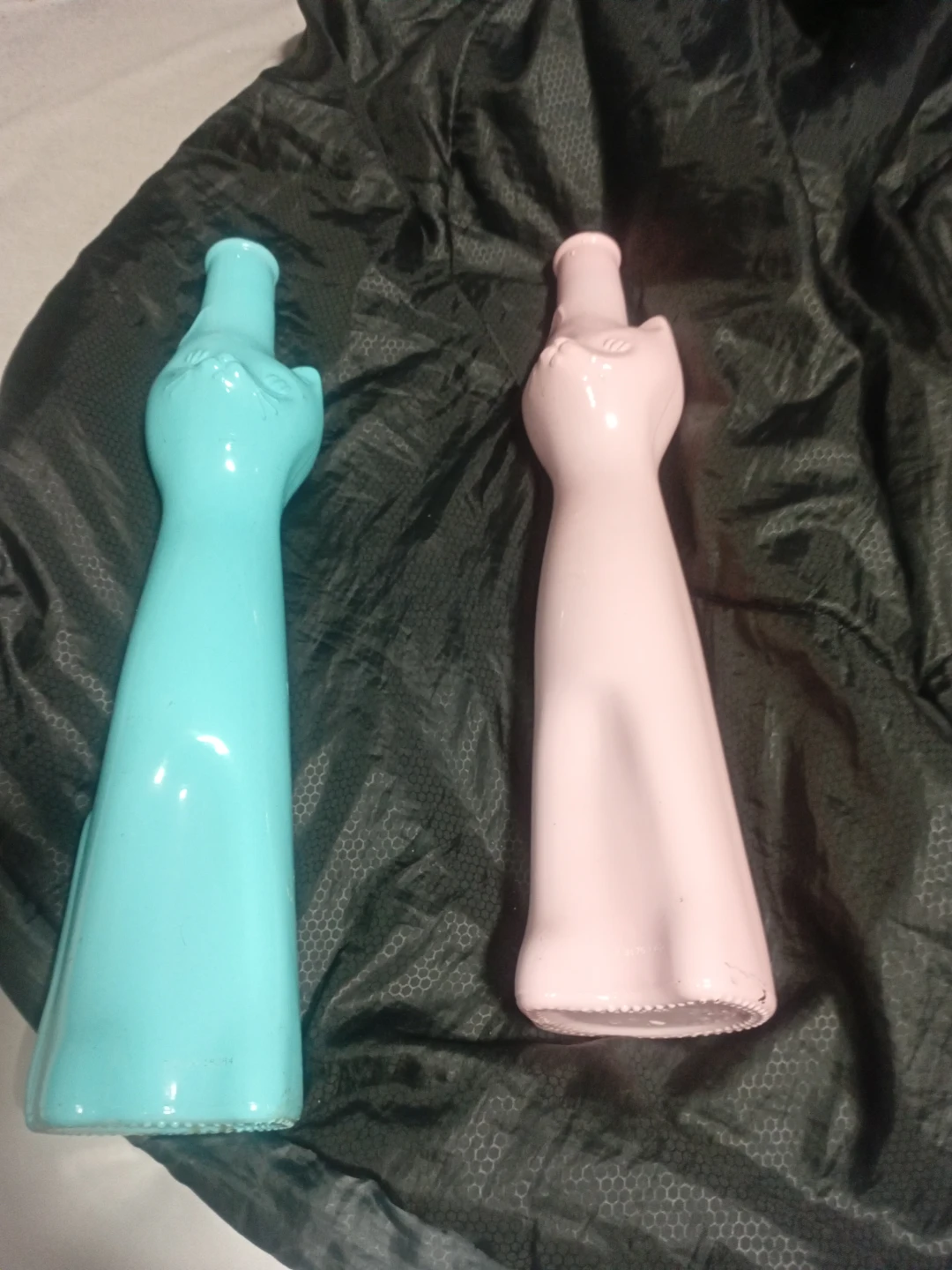 Two decorative cat-shaped bottles