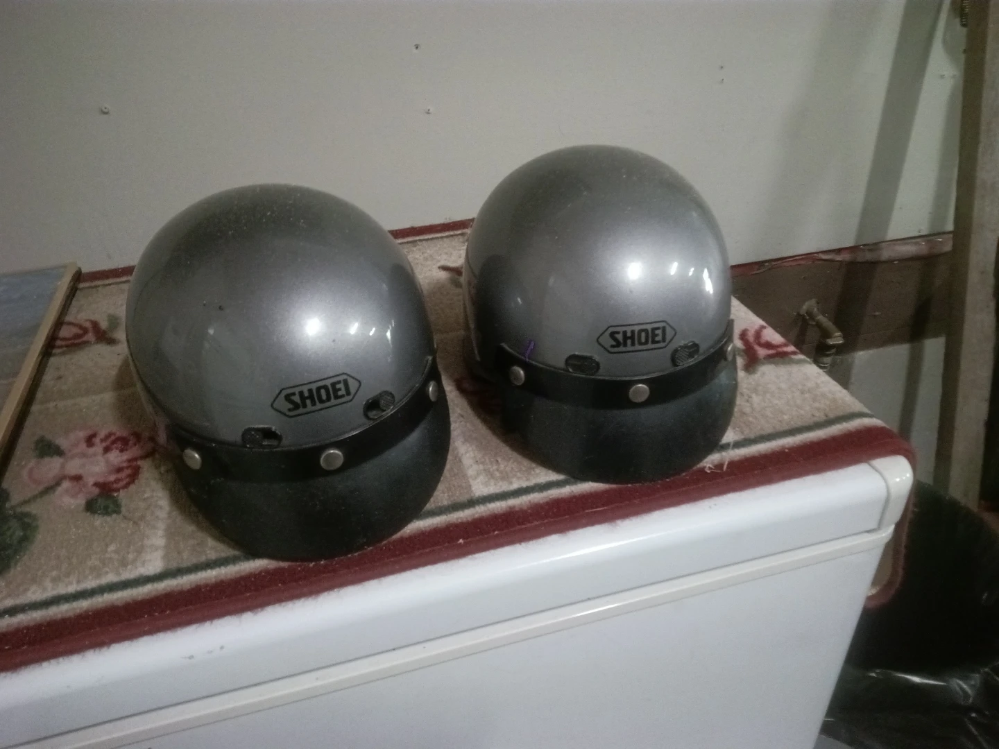 Two Shoei motorcycle helmets