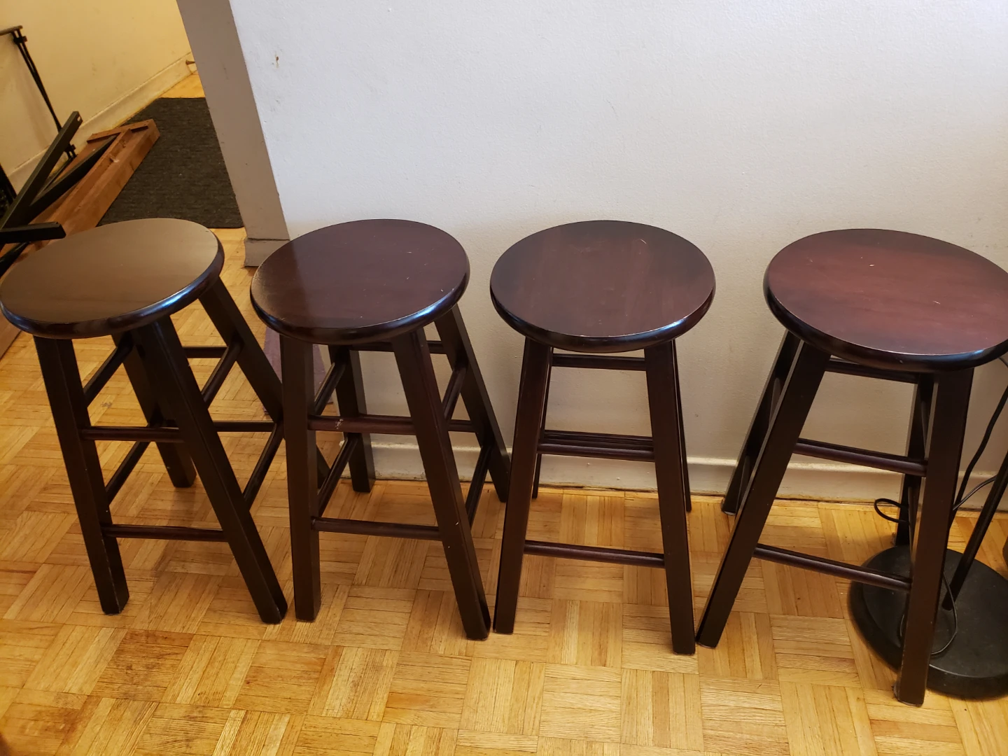Four Dark Wood Round Bar Stools