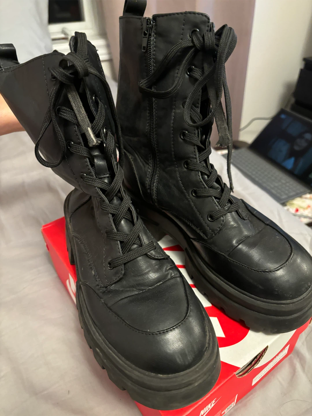 Black lace-up combat boots