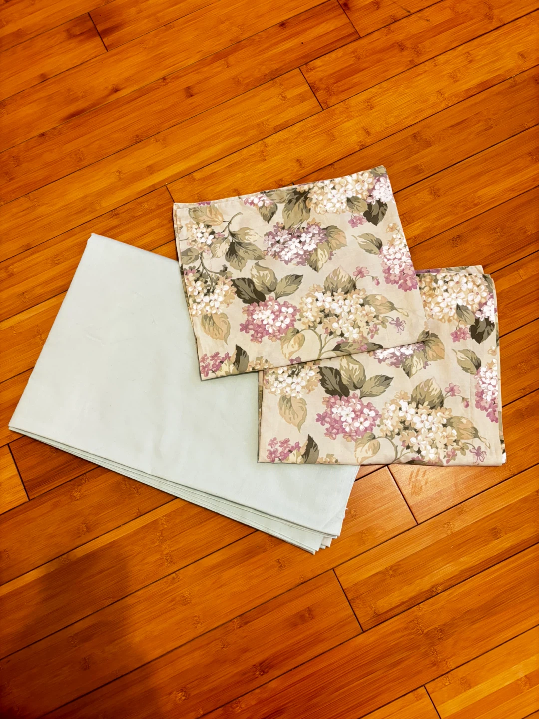 Two Floral Pillow cases and Solid bed sheet