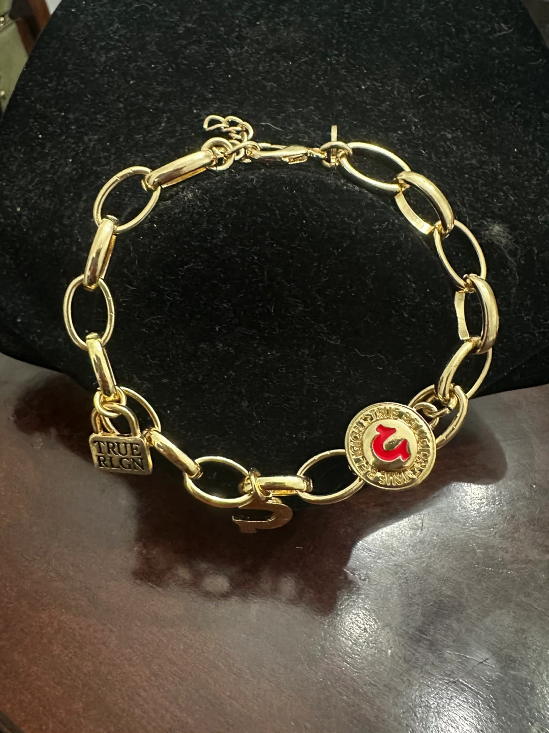 True Religion gold tone charm bracelet