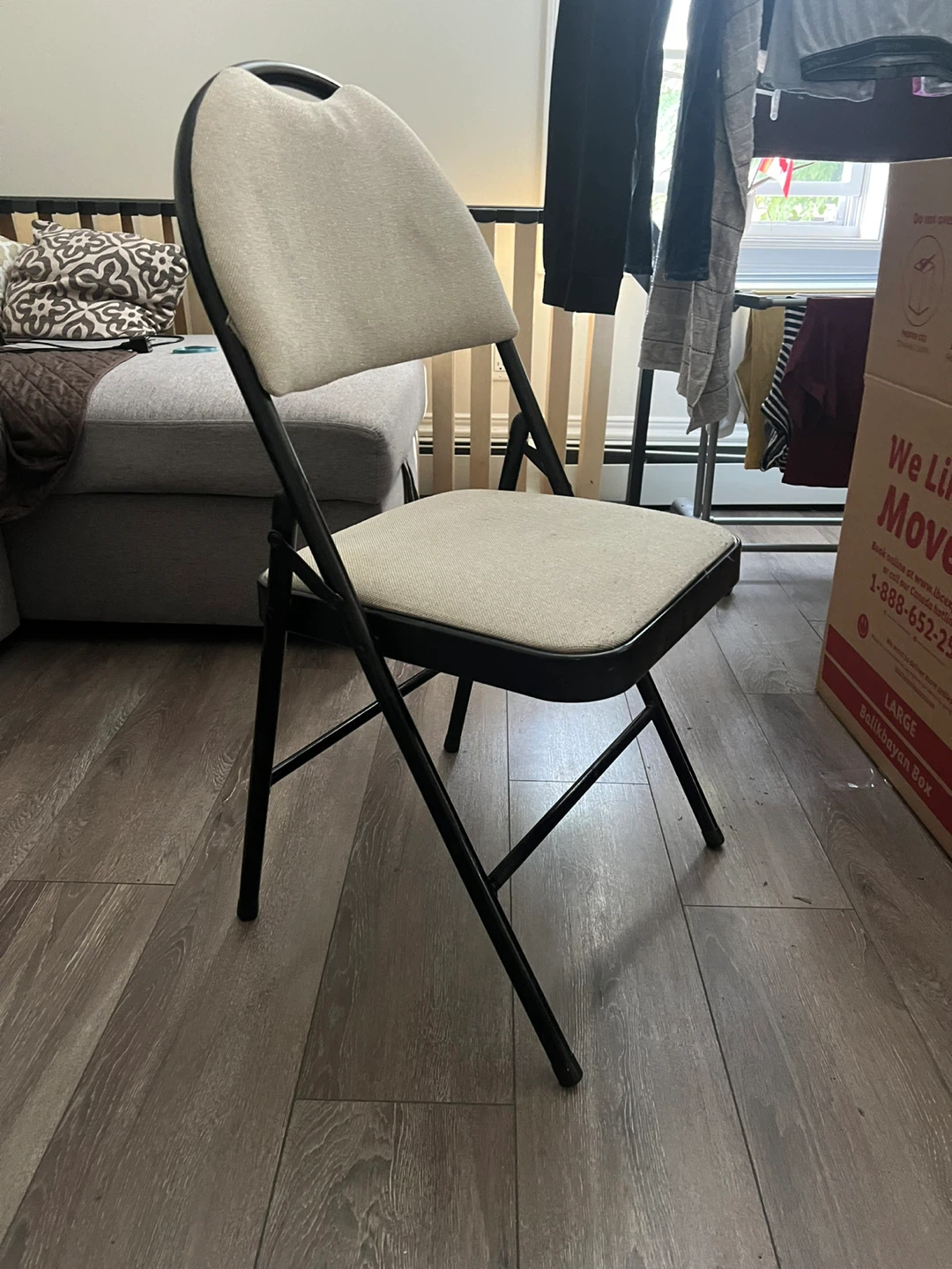 Black Folding Chair with Beige Padded Seat (used)