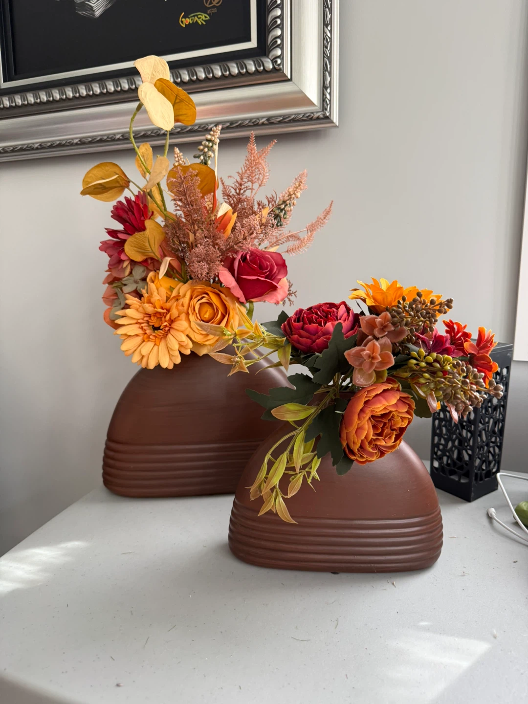 Set of two decorative brown vases with artificial flowers
