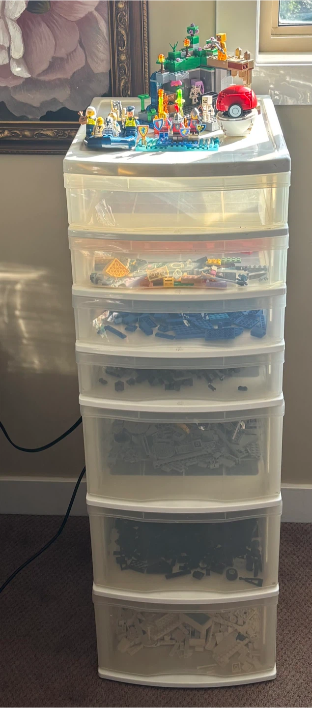 Assorted LEGO Pieces and Minifigures in Storage Unit