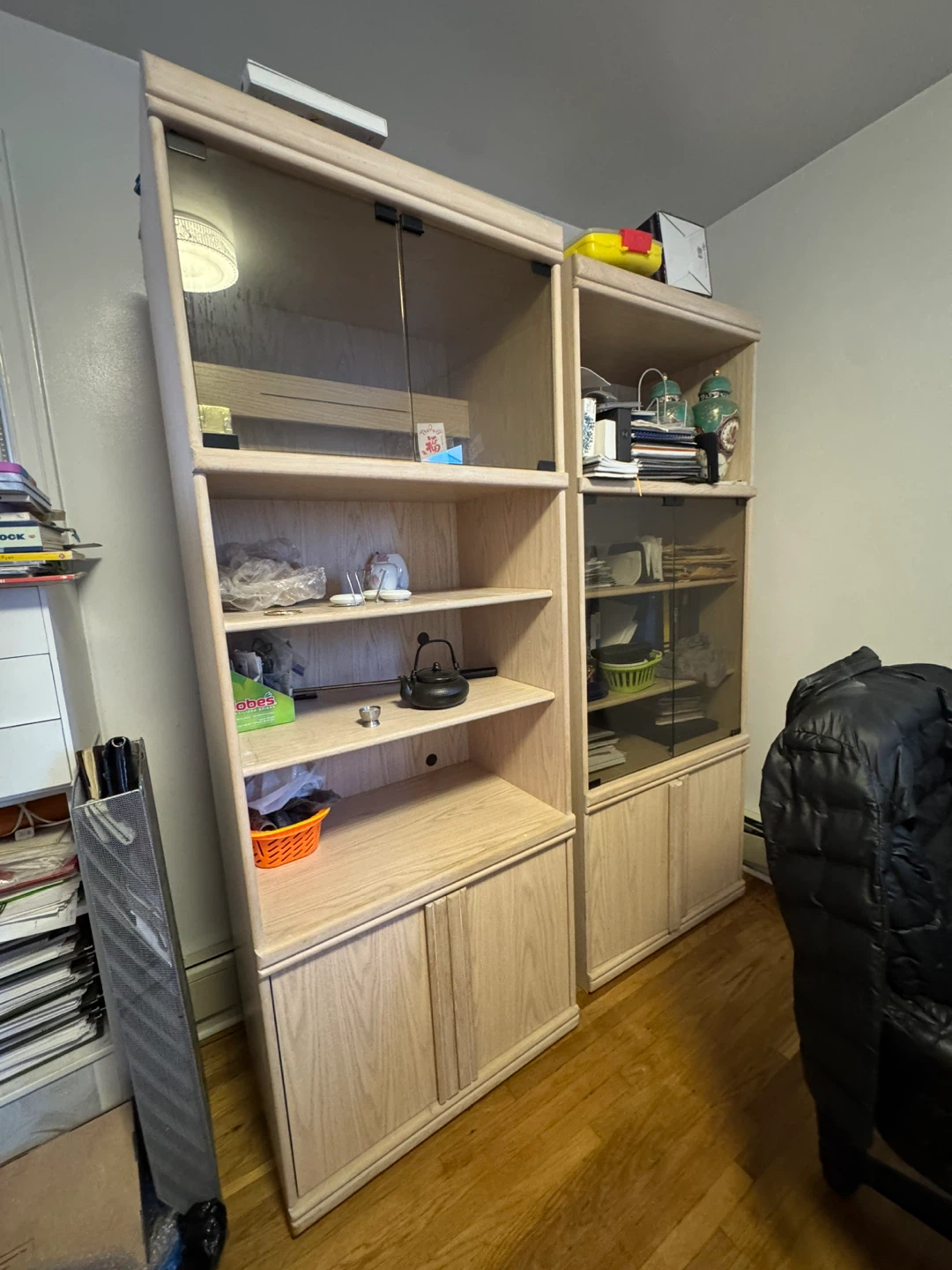 Light wood display cabinet with glass doors