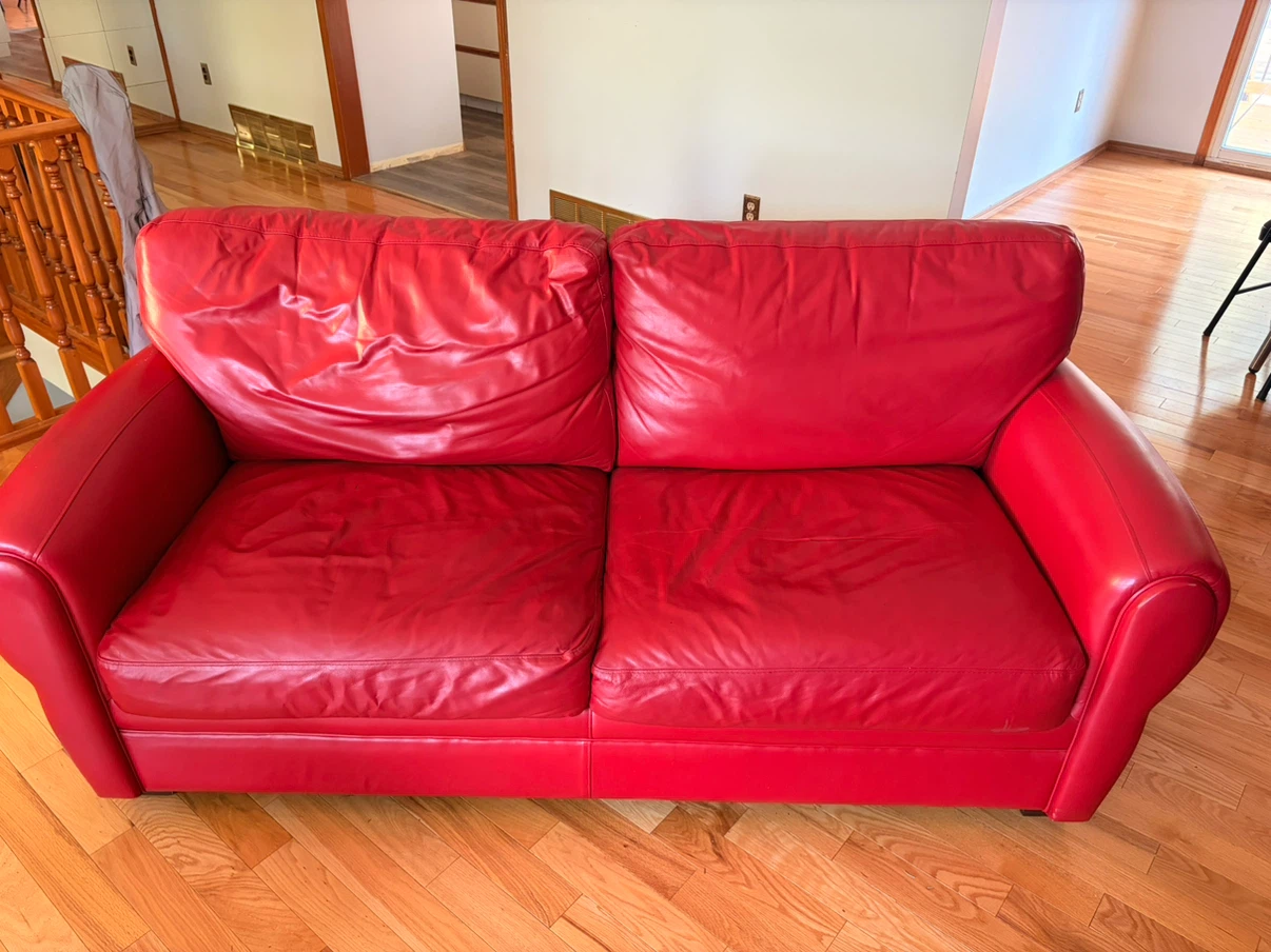 Red leather two-seater sofa