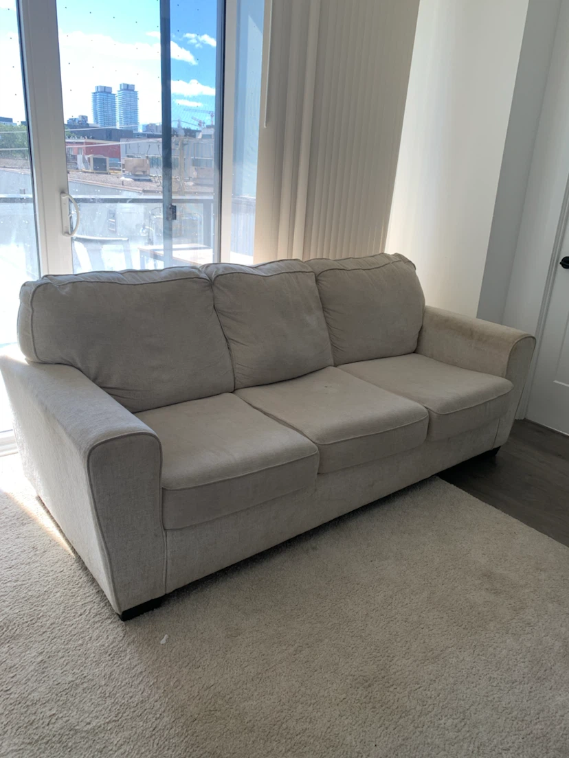 Three-seater beige sofa