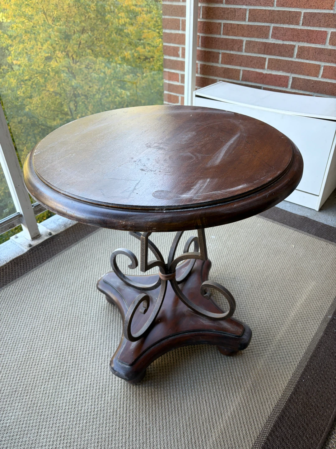 Round wooden side table with metal base
