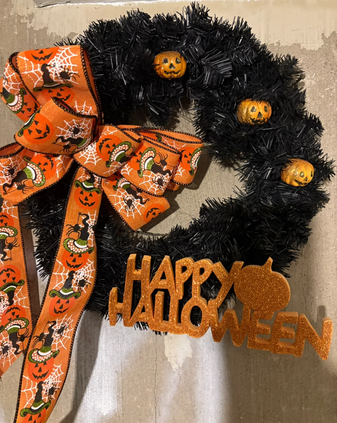Halloween wreath with pumpkins and ribbon
