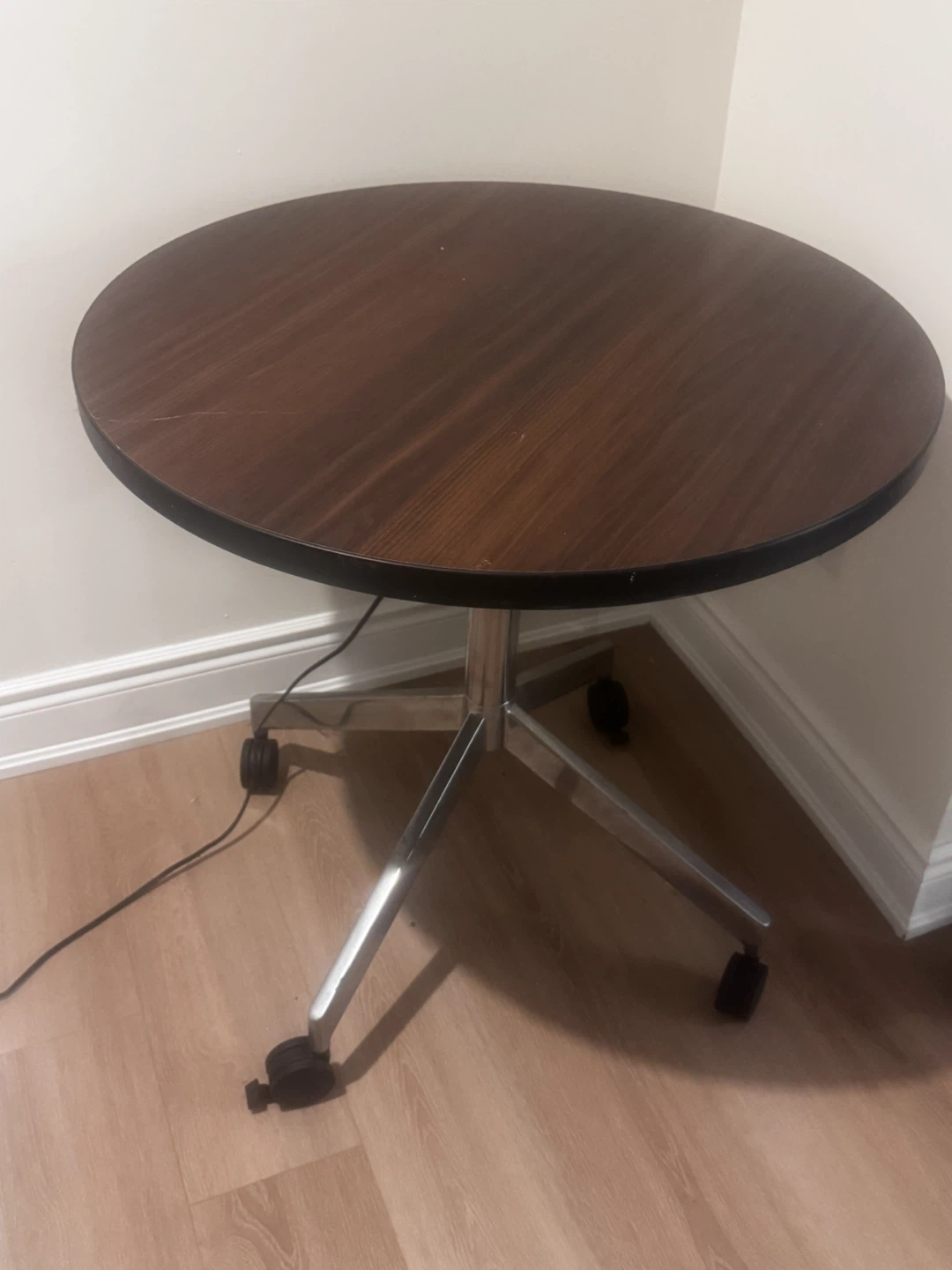 Round wooden table with metal base