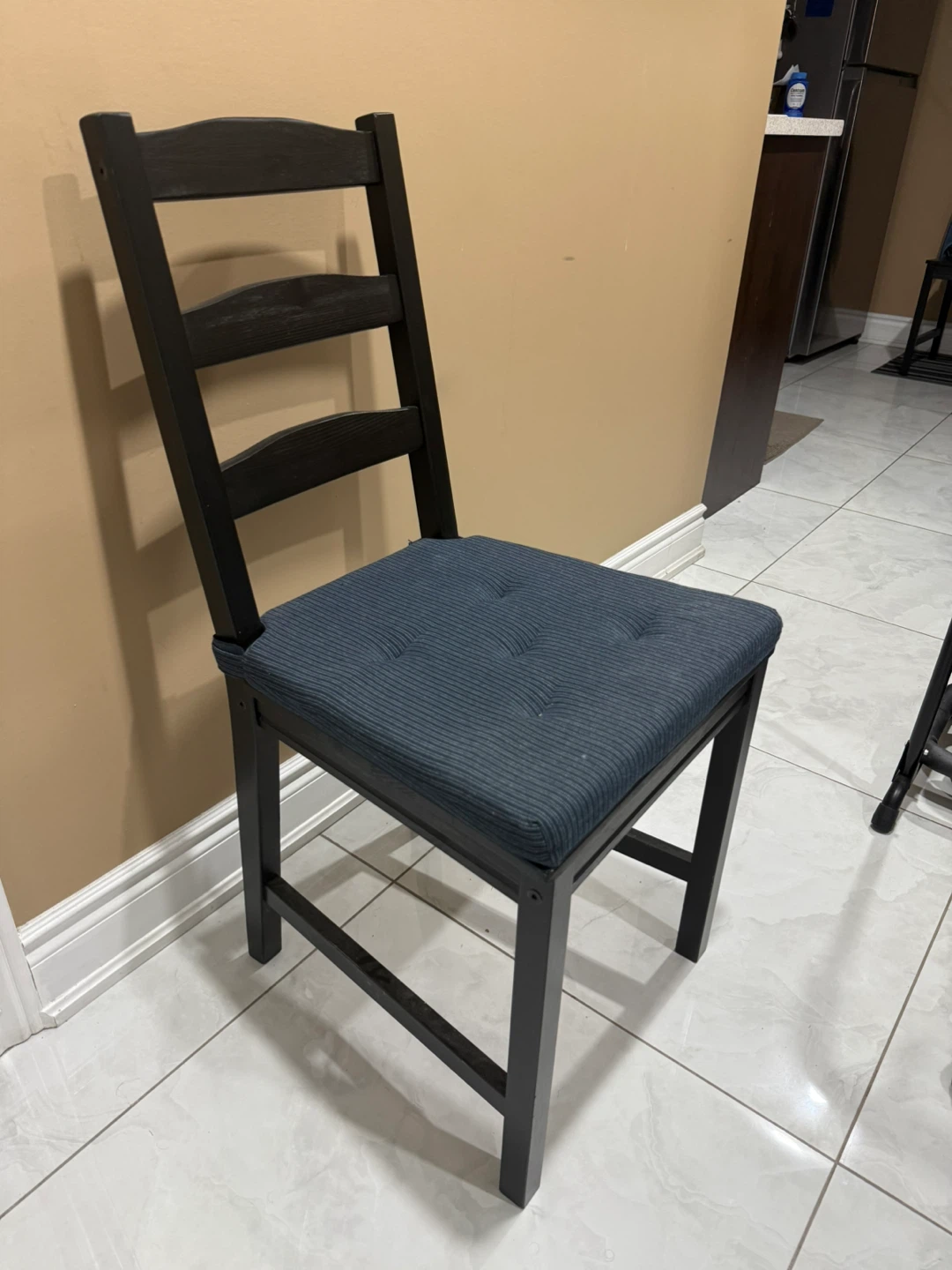 Dark wood dining chair with blue cushion