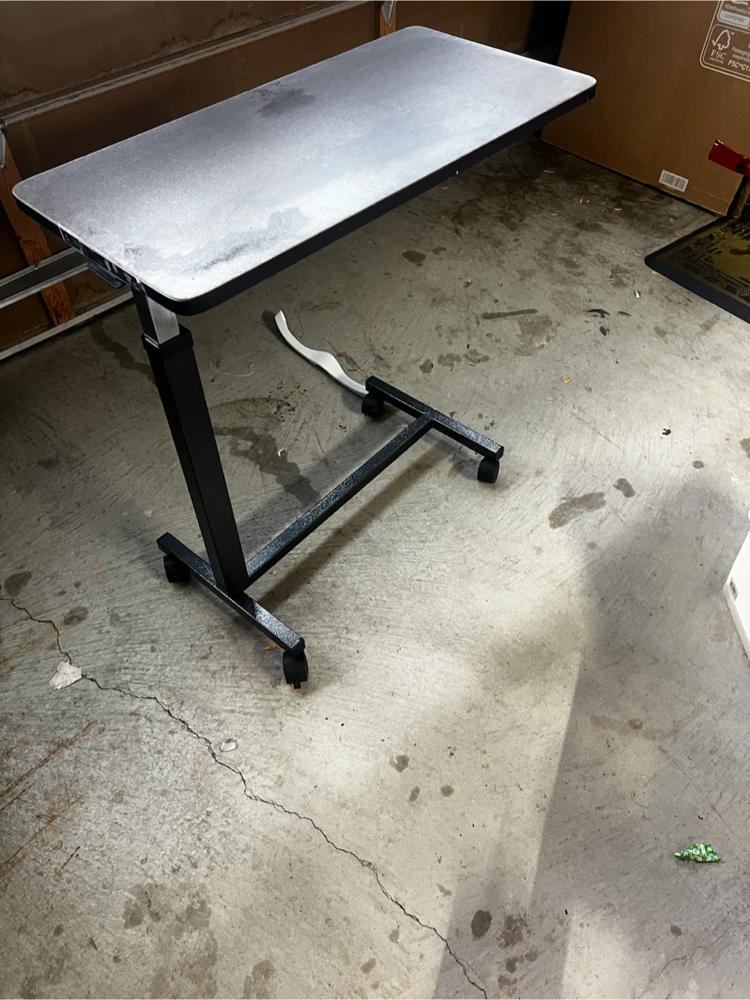 Adjustable rolling overbed table