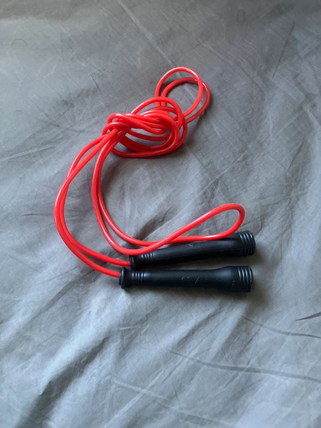 Red jump rope with black handles