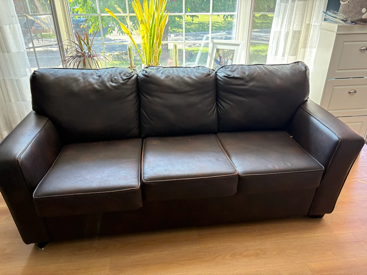 Dark brown leather three-seater sofa
