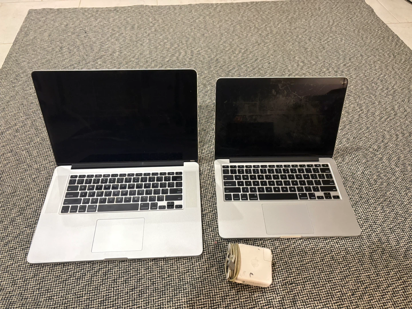 Two Apple MacBook Laptops with Charger