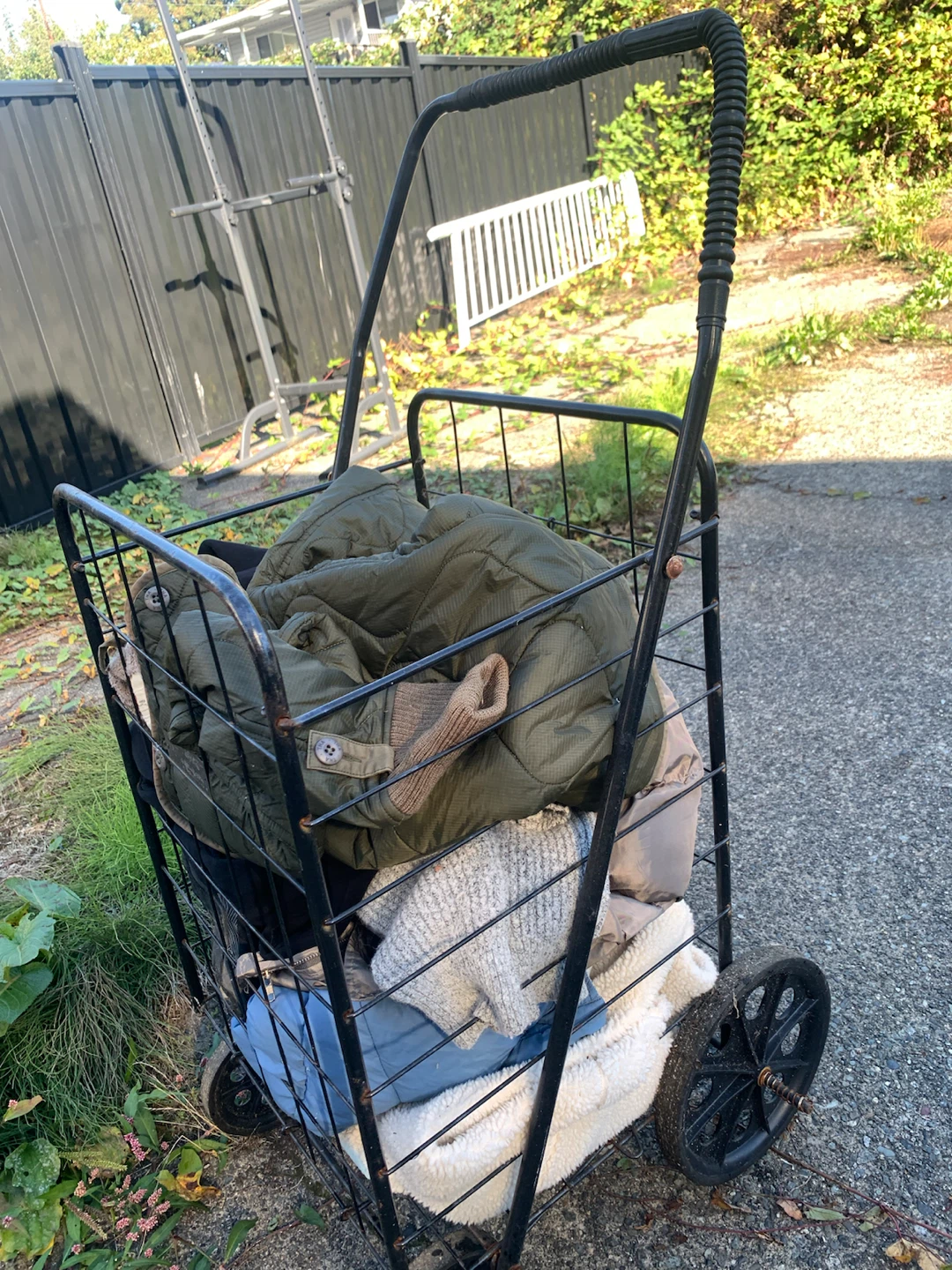 Metal shopping cart and assorted clothing bundle - photo 2