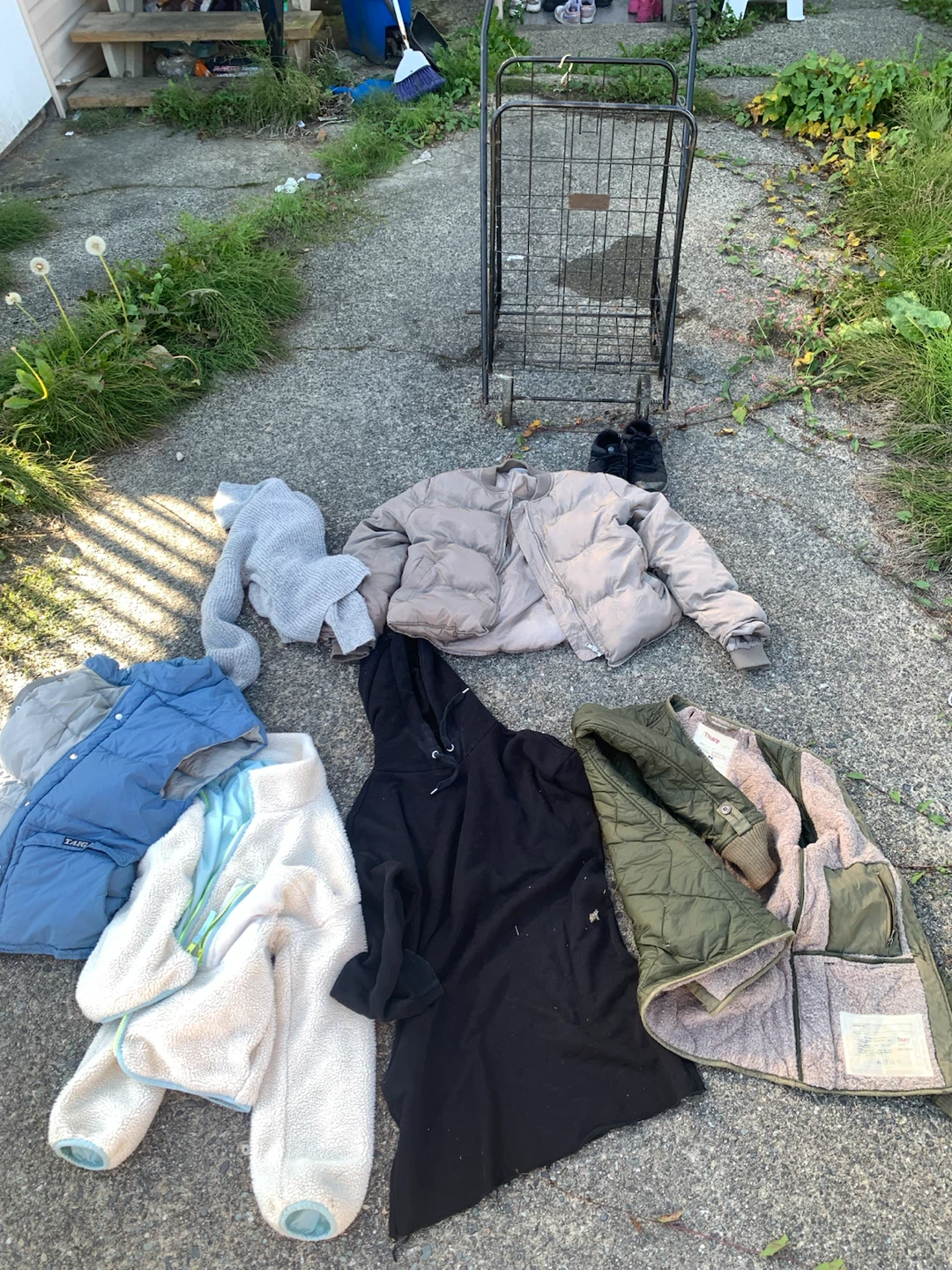 Metal shopping cart and assorted clothing bundle - photo 3