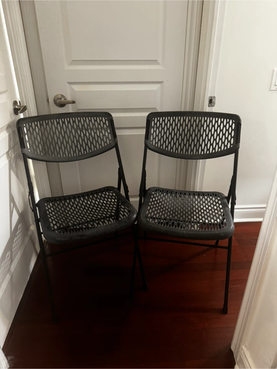 Two black metal folding chairs