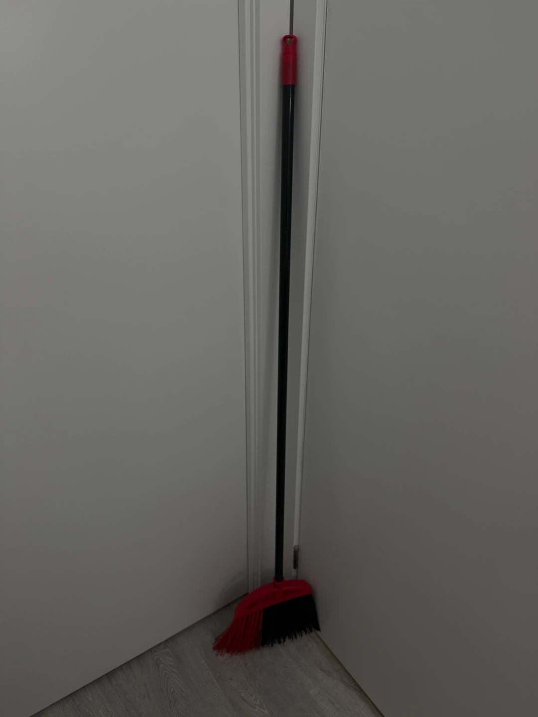 Red and black long handled broom
