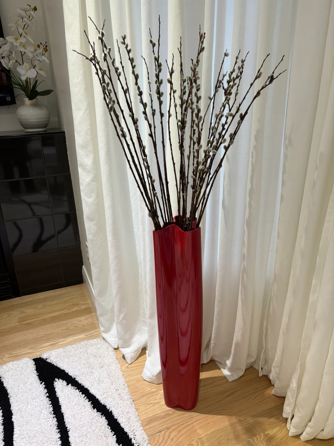 Red ceramic vase with pussywillows