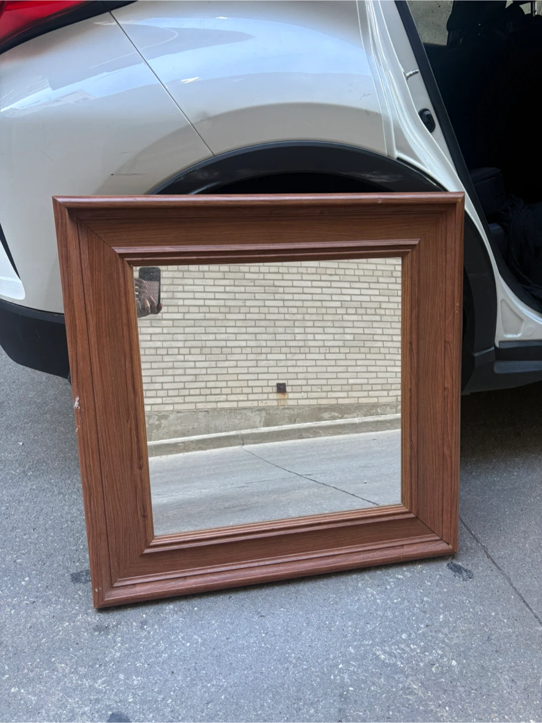 Wall mirror with wood-tone frame