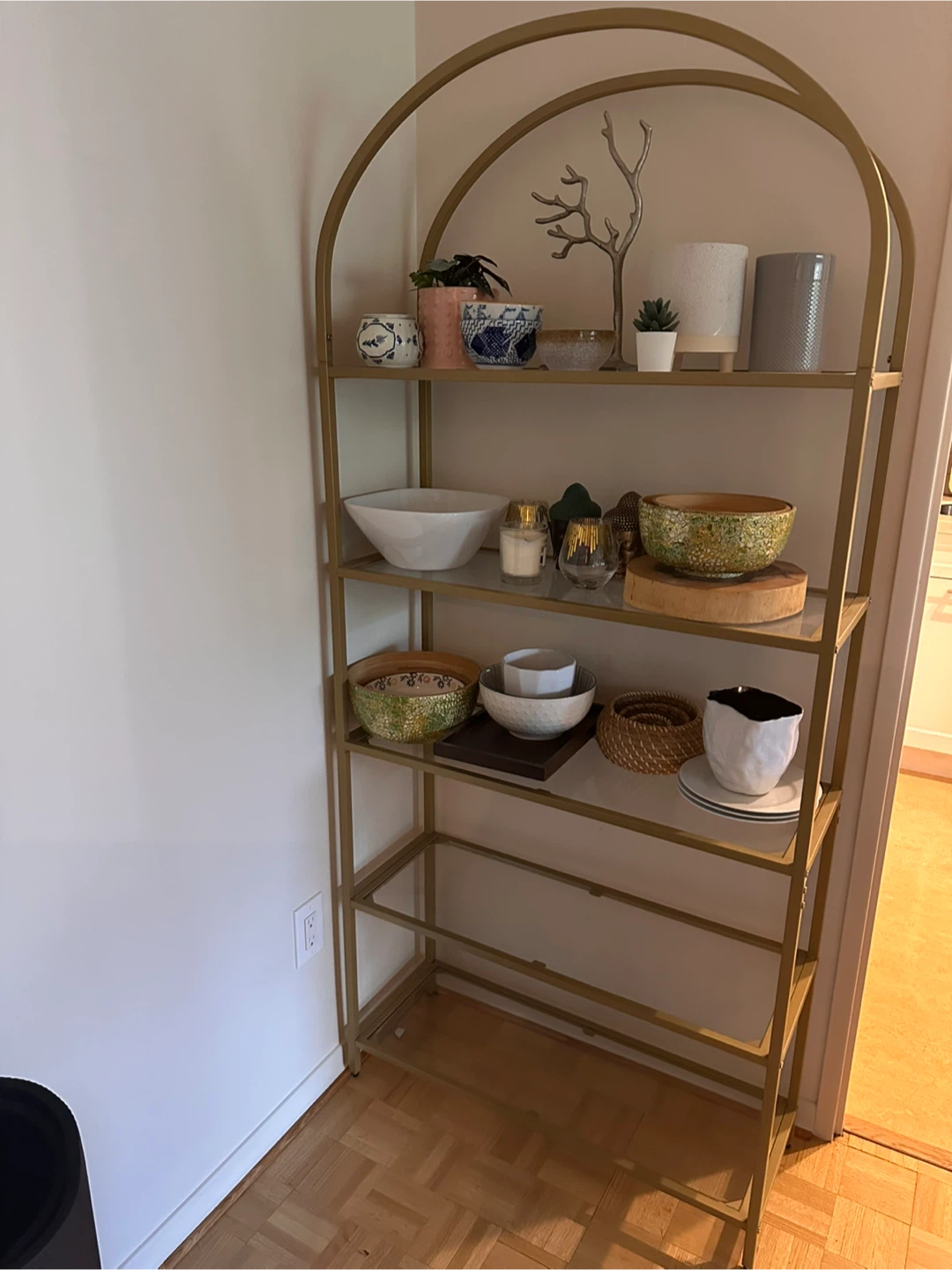 Gold arched metal shelving unit