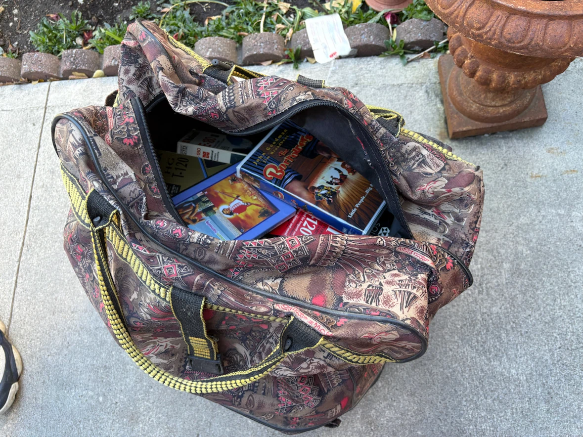 Patterned travel duffel bag, comes with tons of VHS tapes