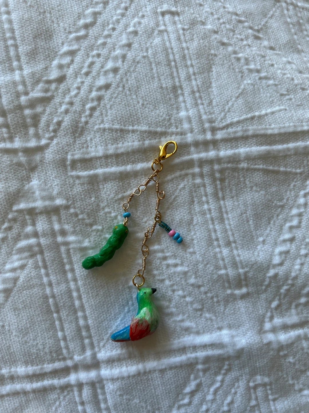Handmade clay bird and worm charm