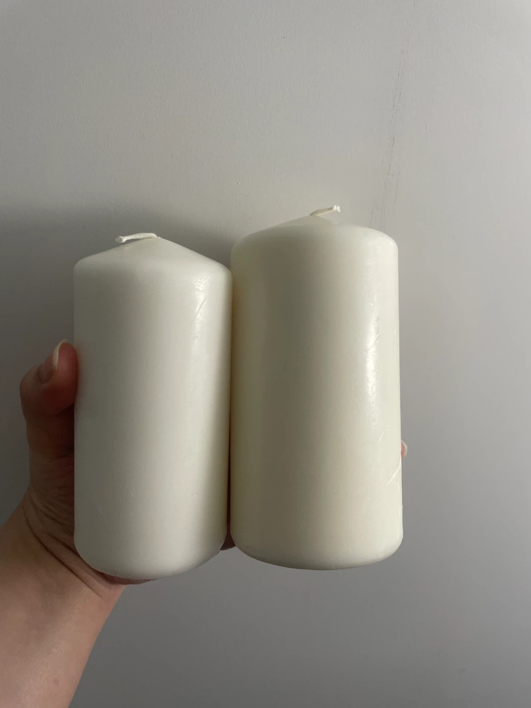 Two white pillar candles