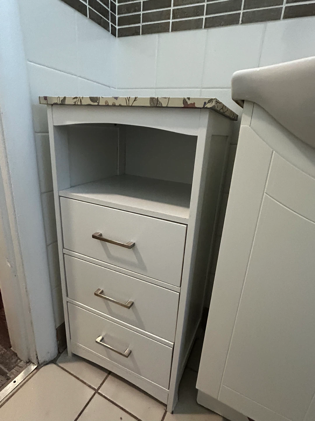 White bathroom cabinet with three drawers and floral top - photo 2
