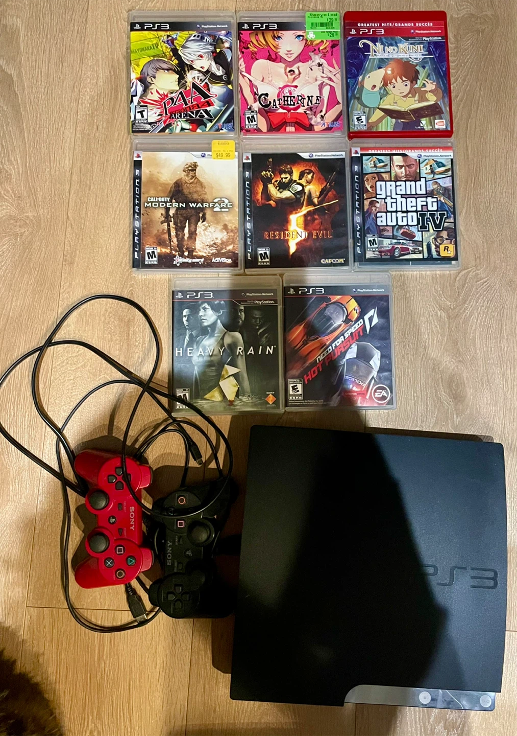 Sony PlayStation 3 Console with 2 Controllers and 8 Games