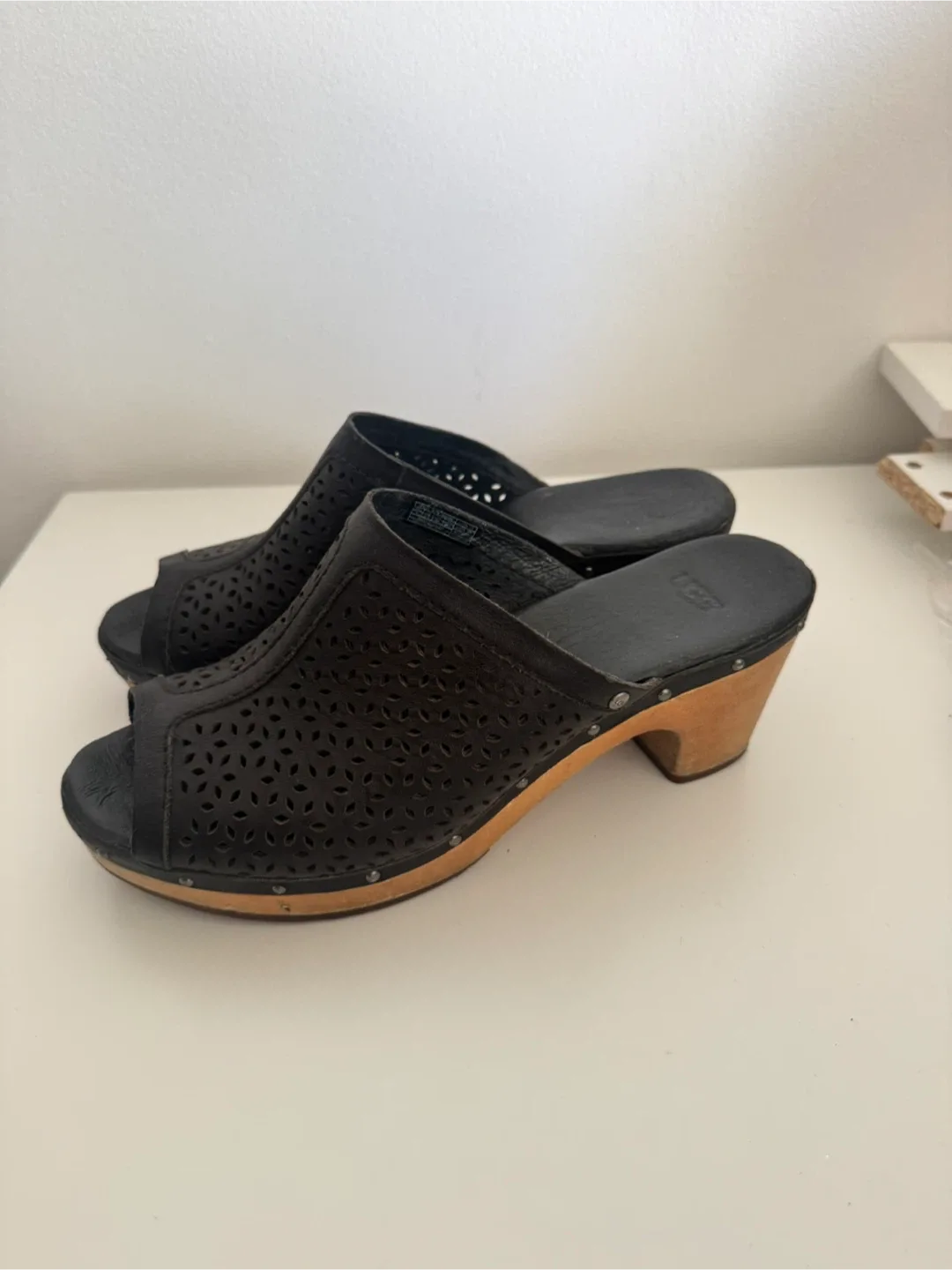 UGG black leather laser-cut clogs