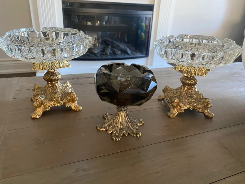 Three vintage glass and brass pedestal ashtrays