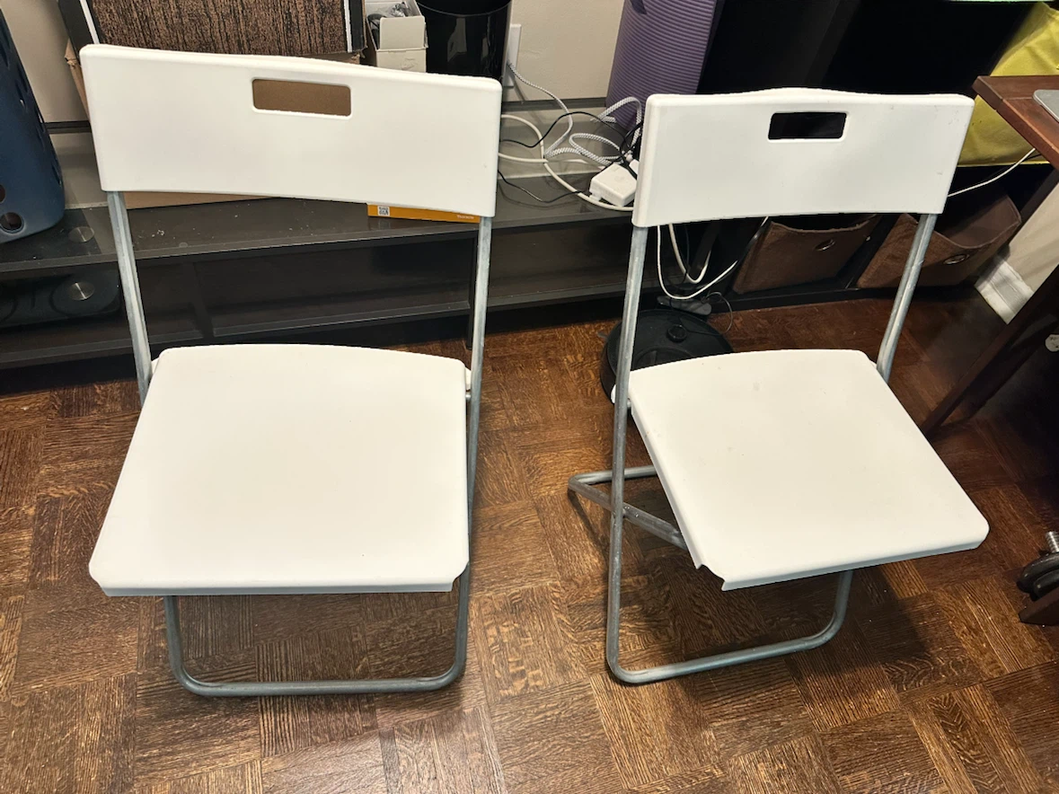 Set of two Ikea white folding chairs