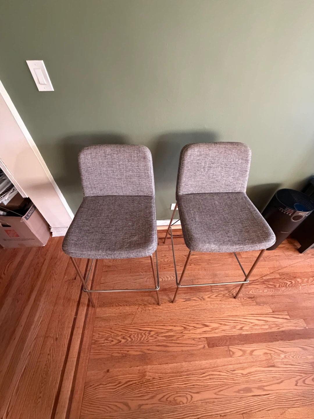 Two CB2 Gray Upholstered Bar Stools